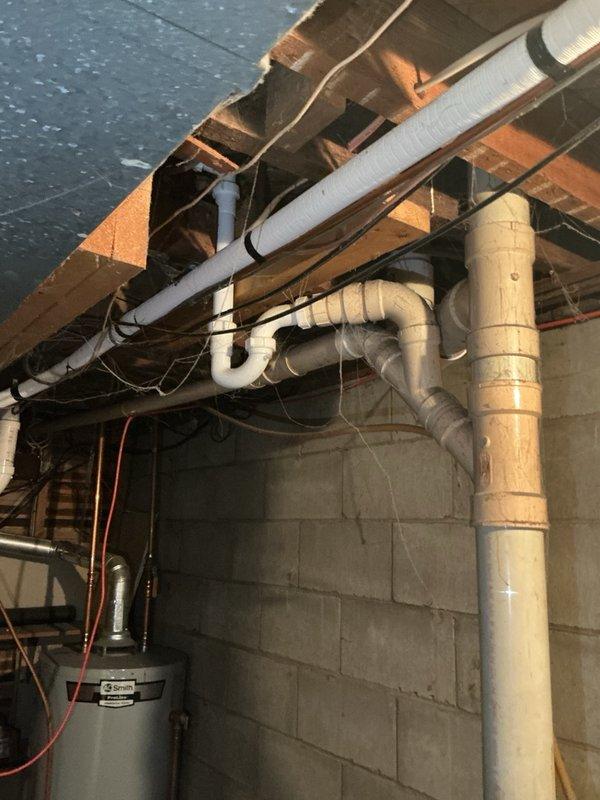 Completed comprehensive plumbing maintenance inspection of residential basement utility area as part of recurring preventive maintenance program. Inspected all accessible plumbing systems including water heater connections, PVC drainage lines, copper supply piping, and associated fixtures. Documented existing conditions of exposed plumbing infrastructure, verified proper support and securing of all piping, and confirmed water heater operational status with no immediate concerns identified at time of inspection.