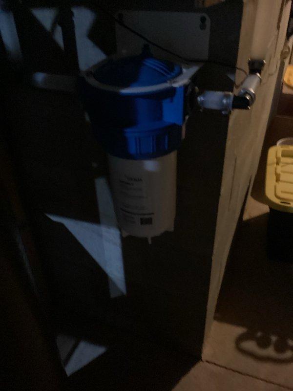 Completed recurring plumbing inspection of residential property. Identified and resolved whistling noise issue in toilet caused by defective fill valve; removed old fill valve and installed new replacement unit. Inspected and documented water filtration system consisting of three Culligan filter units with proper mounting and blue tubing connections in utility area, confirming operational status of all components.