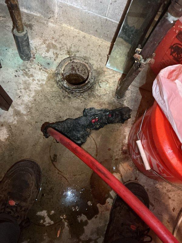 Responded to main sewer line backup causing multiple drains throughout the property to fail. Upon inspection, identified blockages at two locations: between 79-84 feet and at 125 feet in the main line. Successfully cleared and camera inspected the closer blockage point, documenting the condition of the line. Due to the severity and distance of the secondary obstruction at 125 feet, scheduled follow-up service with hydro-jetting equipment to properly address the deeper blockage. Photographed standing water and drainage issues in basement area, including floor drain conditions and affected plumbing infrastructure showing signs of moisture exposure and corrosion.