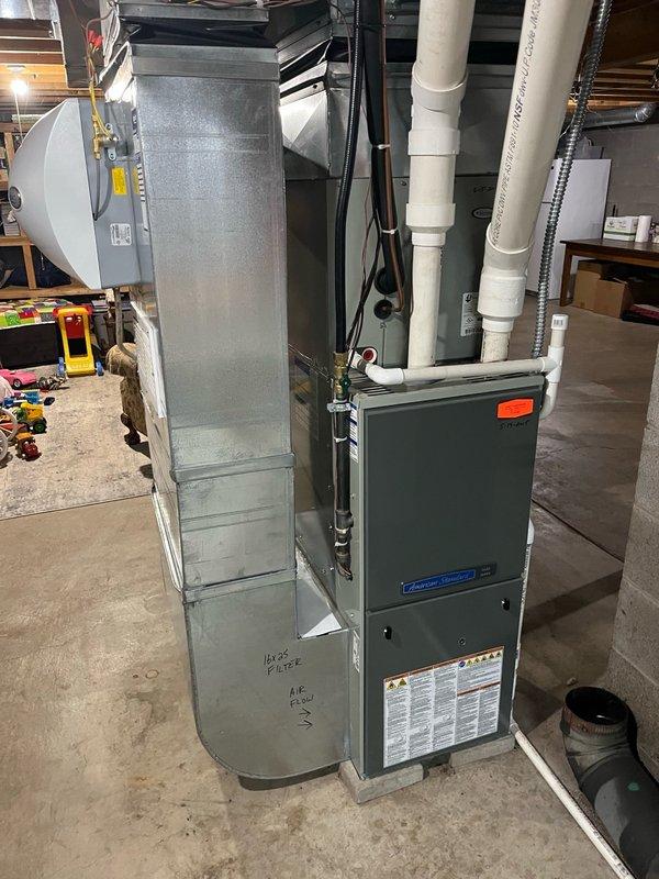 Completed comprehensive furnace tune-up and safety inspection on American Standard/Trane unit. Performed routine maintenance checks including filter inspection, blower assessment, and line clearance verification—all components found within normal operating specifications. Conducted operational testing with 15-minute run cycle, confirming proper system function with 50° temperature rise across heat exchanger.

During safety inspection, identified cracking beginning at burner inlet on primary heat exchanger and early signs of leakage developing on secondary heat exchanger. Documented findings with photographic evidence showing heat exchanger condition and overall system installation. Provided on-site explanation of heat exchanger deterioration and areas of concern, noting that given the age and current condition of both heating and cooling equipment, evaluation of repair versus replacement options would be advisable. System currently operational but monitoring recommended due to heat exc