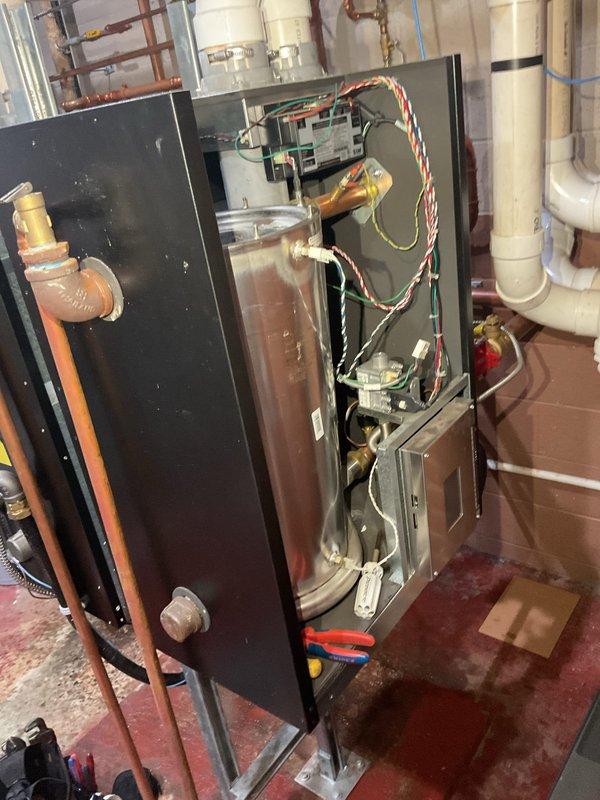 Performed comprehensive maintenance on two commercial boilers including cleaning of heat exchangers, flame sensors, and condensate systems. Replaced circulator pump on boiler nearest to door with inventory unit. Successfully freed and restored operation of seized garage pump through mechanical intervention. Installed manual switch on garage pump system to allow seasonal shutdown and extend equipment lifespan. All systems tested and operational upon completion.
