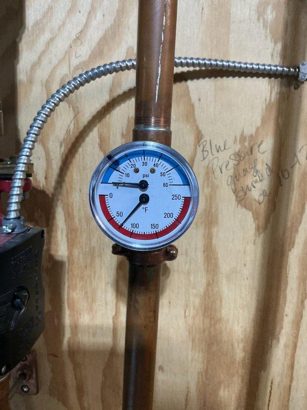Responded to no heat call on 2007 Munchkin boiler serving radiant in-floor heating system. Upon arrival, found system experiencing recurring low pressure issues and short cycling. Diagnostic testing revealed failed thermostat, compromised ignitor and flame sensor causing cycling issues. Jumped thermostat wires to isolate and confirm thermostat failure. Further inspection identified significant heat exchanger deterioration - unit showing signs of plugging, burnout, and active water leakage through heat exchanger. System pressure loss traced to failed heat exchanger. Documented gauge readings and internal component condition with photos. Advised that heat exchanger failure on this 17-year-old unit represents unsafe operating condition with continued water loss and no viable repair option. Provided temporary restoration by replacing thermostat to restore immediate operation, but strongly recommended complete boiler replacement due to failed heat exchanger presenting safety hazard and immi