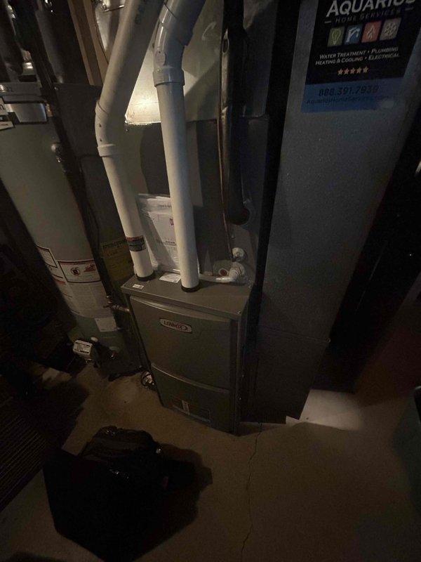 Completed comprehensive furnace tune-up on 2-year-old Lennox system, performing full inspection of all components including blower assembly, motor, and heat exchanger with all equipment operating within normal parameters. Investigated homeowner's report of basement noise, identified source as hissing toilet rather than HVAC equipment, and temporarily resolved issue by shutting off water supply to fixture. Provided thermostat operation instruction to address homeowner's questions about system controls.