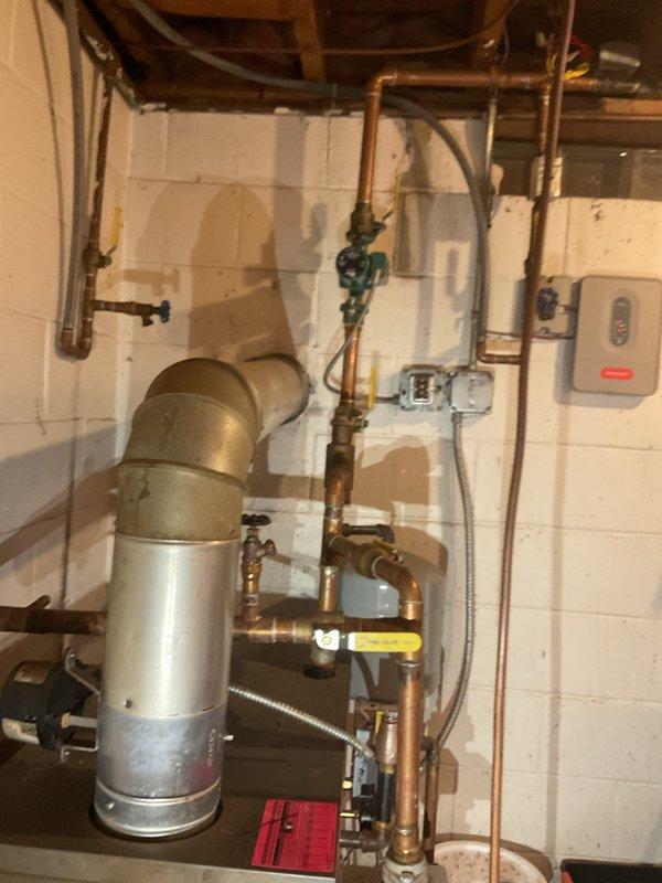 Completed comprehensive boiler tune-up on residential gas heating system, including full inspection per standard maintenance protocol. Addressed reported leak from floor drain valve and added water to system to restore proper operating levels. All components inspected and tested, including copper piping connections, expansion tank, valves, and controls. System confirmed operating properly upon completion with no safety concerns identified.