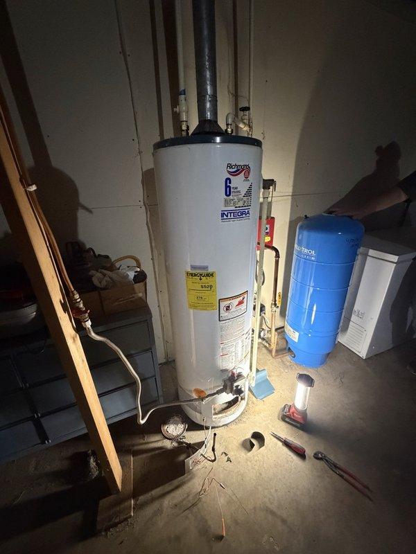 Responded to service call for water heater failing to maintain pilot light and insufficient hot water production. Upon inspection, determined the 17-year-old Richmond Integrex tanked water heater had a pilot light that would not remain lit, indicating potential thermocouple failure or gas valve malfunction. Assessed the unit's overall condition and age, noting it had exceeded typical service life expectancy. Provided homeowner with two service options: cleaning the burner assembly to attempt repair of the pilot light issue, or complete water heater replacement. Given the advanced age of the unit and the likelihood of additional component failures, recommended full replacement as the most cost-effective long-term solution. Homeowner elected to proceed with new water heater installation. Prepared detailed estimate for replacement work and obtained signed approval to move forward with installation scheduling. Documented existing installation configuration including connections to expansio