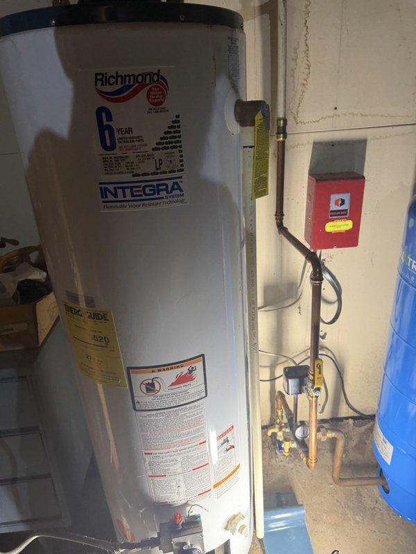 Responded to service call for water heater failing to maintain pilot light and insufficient hot water production. Upon inspection, determined the 17-year-old Richmond Integrex tanked water heater had a pilot light that would not remain lit, indicating potential thermocouple failure or gas valve malfunction. Assessed the unit's overall condition and age, noting it had exceeded typical service life expectancy. Provided homeowner with two service options: cleaning the burner assembly to attempt repair of the pilot light issue, or complete water heater replacement. Given the advanced age of the unit and the likelihood of additional component failures, recommended full replacement as the most cost-effective long-term solution. Homeowner elected to proceed with new water heater installation. Prepared detailed estimate for replacement work and obtained signed approval to move forward with installation scheduling. Documented existing installation configuration including connections to expansio