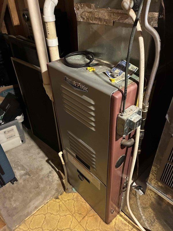 Performed preventative maintenance on two furnace systems for new customer. Downstairs unit (26-27 years old) failed to ignite during testing. Inspection revealed significantly rusted burners and two cracks on heat exchanger face plate at flame entry point. Customer was shown the heat exchanger damage. Due to age and safety concerns, complete system replacement with new furnace and air conditioning unit is recommended for downstairs system. Upstairs unit (25 years old, installed with home addition) showed acceptable heat exchanger condition with all operational parameters within specification except for the inducer motor. Motor is producing excessive noise and drawing amperage above rated capacity, indicating bearing failure. Prepared parts pricing information for inducer motor replacement on upstairs system. Scheduled follow-up appointment to discuss replacement options for downstairs furnace system.