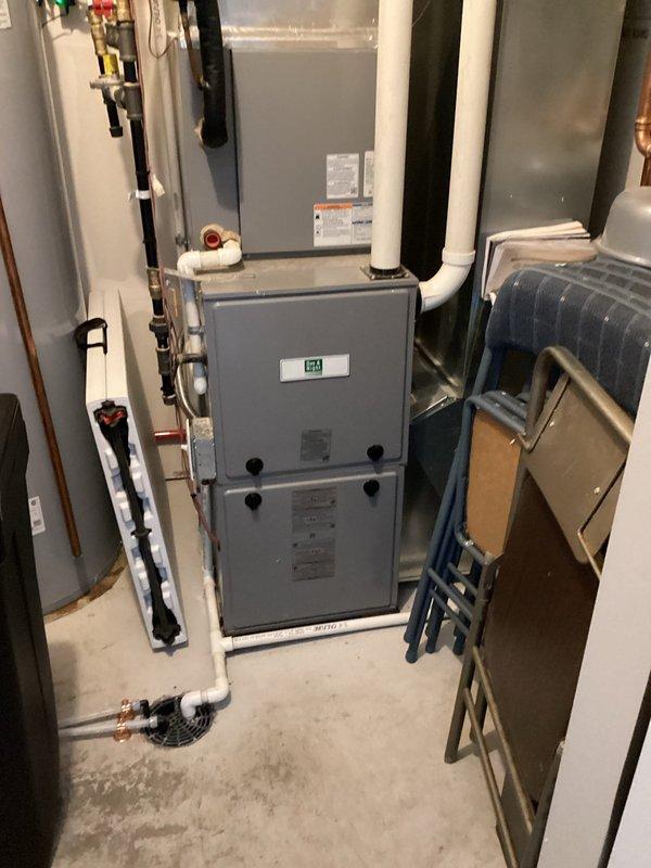 Completed scheduled heating system maintenance on ICP furnace unit as part of Family Rewards agreement. Performed comprehensive tune-up including inspection of all mechanical components, burner assembly, heat exchanger, blower motor, and electrical connections. Verified proper operation of digital thermostat control displaying 68 degrees. Inspected venting system including white PVC exhaust and intake pipes for proper installation and clearances. Checked gas connections, pressure settings, and safety controls. Cleaned and tested ignition system. Measured temperature rise and confirmed within manufacturer specifications. Inspected condensate drainage system for proper flow. All components found operating within normal parameters with no active issues reported. System running efficiently with no deficiencies noted.