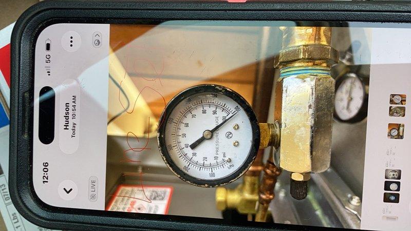 Returned to site to check nitrogen pressure on system and isolate AC refrigerant leak. Pressure test showed system dropped from 180 PSI to 140 PSI, confirming active leak. Installed three test gauges to isolate line set, A-coil, and condensing unit to determine leak location. Accessed gym area and soffit to inspect for visible leaks in line set. Due to pressure drop and leak location uncertainty, system components remain isolated with gauges in place for extended pressure monitoring at next visit to pinpoint whether leak is in line set, evaporator coil, or condensing unit before proceeding with repairs.
