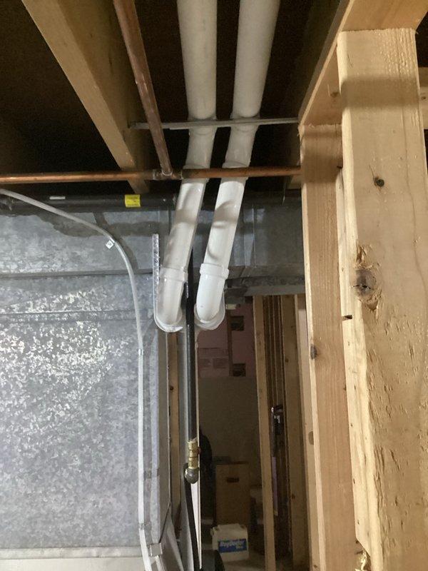 Completed return visit to address code violations on furnace installation. Installed proper copper ground wire to furnace switch per electrical code requirements. Corrected intake venting that was positioned below the minimum 12" above grade requirement per SPS 323.14 (3)(b). Replaced all furnace venting and reconfigured system by swapping intake and exhaust termination locations to meet manufacturer specifications and proper clearance distances from other exhaust terminations. Documented all corrections with photos showing compliant exterior venting configuration and interior installation.