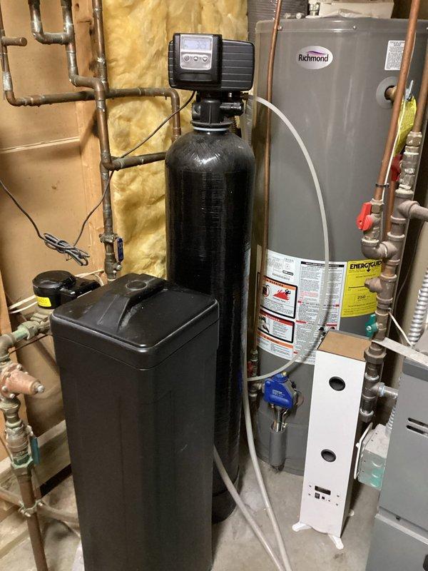 Responded to a water softener malfunction where resin beads had discharged from the unit and contaminated the entire household plumbing system, causing low water pressure and visible particulate matter in the water supply. Systematically cleared resin beads from all water lines throughout the residence, replaced two toilet fill valves, one lavatory faucet, and one shower head that were damaged or clogged by the contamination. Unclogged and flushed all remaining fixtures to restore normal water flow and pressure throughout the home.