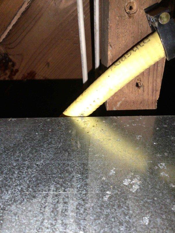 Performed comprehensive furnace tune-up on both units of a duplex property in response to reported gas odor concerns. Upon inspection, confirmed both furnaces were operating properly but discovered a pinhole leak in the gas-tight supply line. Documented the compromised gas line with photos showing the yellow gas line routing through the attic space and created an estimate for complete gas line replacement from the furnace connections to the exterior regulator to ensure safe operation and eliminate the gas leak hazard.