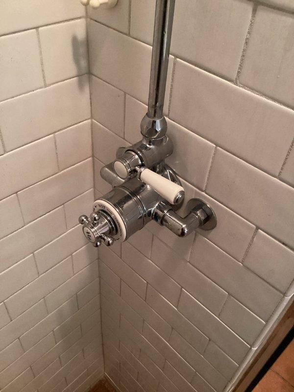 Responded to callback for insufficient hot water issue following previous service visit. Upon arrival, confirmed water temperature only reaching lukewarm throughout residence with shower running cold. Inspected shower valve temperature adjustment mechanism and water heater thermostat settings, finding both set to low positions. Adjusted shower mixing valve temperature limiter and increased water heater thermostat settings to restore proper hot water delivery to fixtures.