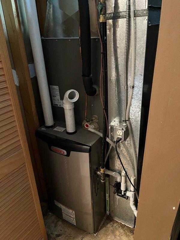 Performed comprehensive furnace and air conditioning tune-up on approximately one-year-old HVAC system installed in utility closet. Upon arrival, homeowner reported no current concerns with system operation. Completed full maintenance protocol on both heating and cooling systems according to standard tune-up specifications. Replaced air filter with customer-supplied unit. Conducted extended operational testing by running both systems for 15 minutes each to verify proper performance. Furnace achieved 65-degree temperature rise, indicating optimal heat exchanger function and proper airflow. Air conditioning system delivered 22-degree temperature drop across the evaporator coil, confirming adequate refrigerant charge and efficient cooling operation. Inspected evaporator coil and noted some surface discoloration and minor oxidation consistent with normal system age and humidity exposure. All components including air handler, ductwork, refrigerant lines, and electrical connections operating