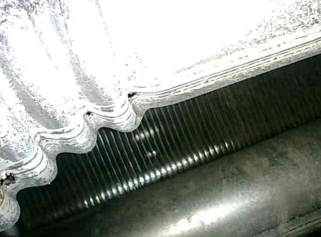 Performed scheduled furnace tune-up and system inspection. During routine maintenance, discovered critical safety issue: holes detected in heat exchanger. Documented condition with photographs showing evaporator coils and HVAC components. Advised that heat exchanger replacement or full unit replacement is required due to compromised heat exchanger integrity, which poses potential carbon monoxide hazard and renders unit unsafe for continued operation.