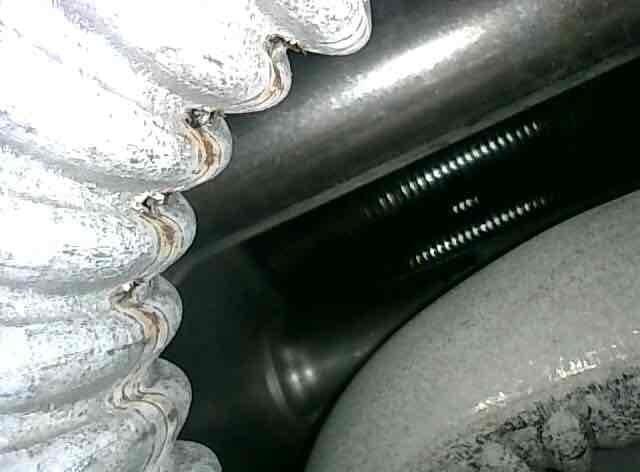Performed scheduled furnace tune-up and system inspection. During routine maintenance, discovered critical safety issue: holes detected in heat exchanger. Documented condition with photographs showing evaporator coils and HVAC components. Advised that heat exchanger replacement or full unit replacement is required due to compromised heat exchanger integrity, which poses potential carbon monoxide hazard and renders unit unsafe for continued operation.