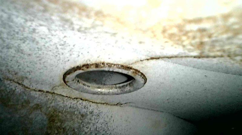 Performed furnace inspection on Val-Pak unit and discovered critical cracks around the eyelet through the limit hole on the heat exchanger, immediately tagging the equipment out of service due to safety concerns. Inspected the blower motor which exhibited rough operation on startup and recommended replacement, while noting the presence of an old brass gas valve that was left in service position. Advised homeowner not to operate the equipment due to carbon monoxide hazard and recommended research into replacement furnace options and carbon monoxide detectors.