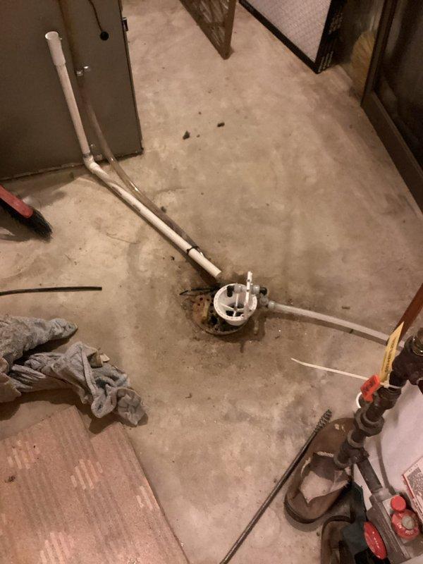 Completed comprehensive plumbing inspection to verify quality of recent repair work. Inspection revealed multiple issues requiring attention, including faucets and garbage disposal that need replacement. Documented under-sink plumbing configuration showing standard P-trap drainage assembly with braided flexible water supply lines, and basement floor drain installation with PVC piping connections in progress.