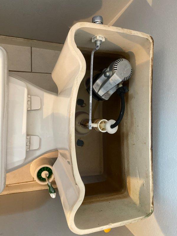 Responded to service call for continuously running toilet. Upon inspection, identified extensive calcium buildup and mineral deposits throughout the internal tank components, affecting the fill valve and flapper mechanism. The existing toilet was an older generic model showing significant age-related deterioration, with visible staining and corrosion inside the tank. 

Determined that repair was not cost-effective given the condition of the fixture. Performed complete toilet replacement, installing a new ADA-compliant toilet to meet current accessibility standards and ensure reliable long-term performance. Removed old toilet, prepared flange and mounting area, set new fixture with proper wax ring seal, secured mounting bolts, and connected water supply line. Tested flush operation and verified proper fill cycle, water level, and seal integrity with no leaks detected.