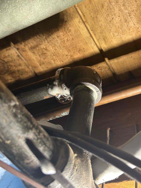Responded to gas leak identified during home efficiency testing. Located active leak at three-quarter inch 90-degree elbow fitting on gas line supplying garage and dryer above furnace area. Due to configuration and accessibility constraints, determined optimal repair method was to cut existing nipple and re-thread pipe with union connection rather than disassembling entire gas line assembly. Obtained homeowner approval and proceeded with repair. Cut affected nipple, re-threaded pipe, and installed union fitting. Performed comprehensive leak check on repaired connection and surrounding gas line components. Confirmed all connections holding properly with no detectable leaks. System restored to safe operating condition.