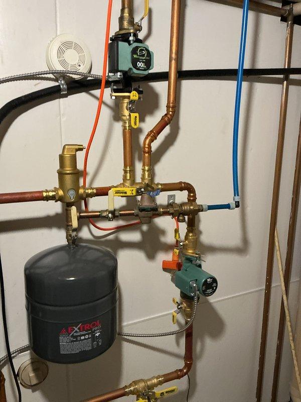 Completed scheduled maintenance on 25-year-old Trane air conditioning system and 3-year-old boiler system with hydronic heating distribution. Inspected multi-zone heating system including Extrol expansion tank, circulator pump, zone valves, brass manifolds, and PEX distribution lines; all components operating within normal parameters. Performed AC tune-up and boiler maintenance per agreement terms; verified proper operation of all equipment with no issues found.