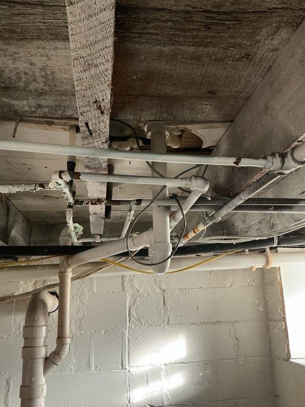 Responded to recurring toilet clog issue at group home facility. Thoroughly inspected toilet operation and downstream PVC drainage system, finding no mechanical defects or blockages in the fixture or drain lines. Toilet demonstrated proper flush function and water flow. Based on facility usage patterns, determined recurring clogs likely caused by excessive disposal of wipes or similar non-flushable materials in the drainage system. During inspection, identified multiple active leaks in existing galvanized water supply piping throughout the basement area, with visible corrosion and deterioration present on vertical and horizontal pipe runs. Documented condition of aging galvanized plumbing infrastructure with photographic evidence showing rust, corrosion, and pipe degradation. Advised property management of findings and recommended full water supply repipe to address failing galvanized lines and prevent future water damage. Verified toilet functionality and confirmed drainage system int