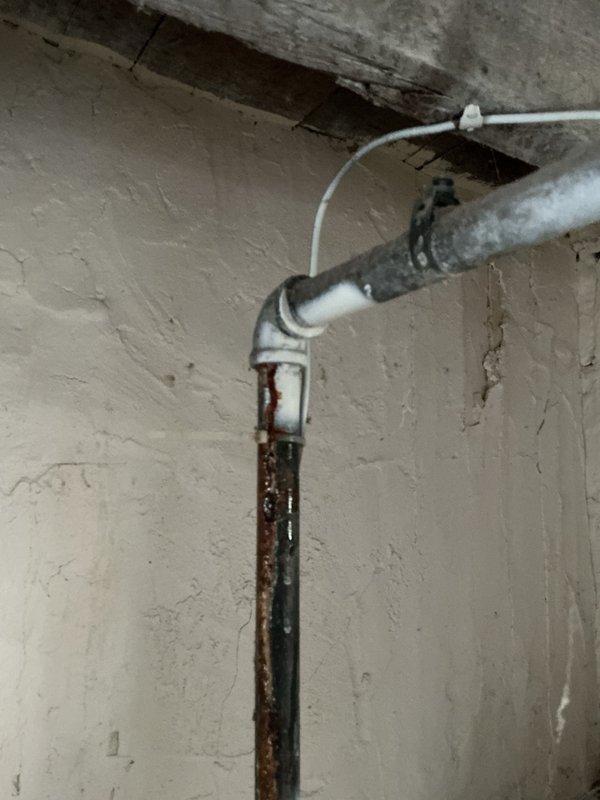 Responded to recurring toilet clog issue at group home facility. Thoroughly inspected toilet operation and downstream PVC drainage system, finding no mechanical defects or blockages in the fixture or drain lines. Toilet demonstrated proper flush function and water flow. Based on facility usage patterns, determined recurring clogs likely caused by excessive disposal of wipes or similar non-flushable materials in the drainage system. During inspection, identified multiple active leaks in existing galvanized water supply piping throughout the basement area, with visible corrosion and deterioration present on vertical and horizontal pipe runs. Documented condition of aging galvanized plumbing infrastructure with photographic evidence showing rust, corrosion, and pipe degradation. Advised property management of findings and recommended full water supply repipe to address failing galvanized lines and prevent future water damage. Verified toilet functionality and confirmed drainage system int