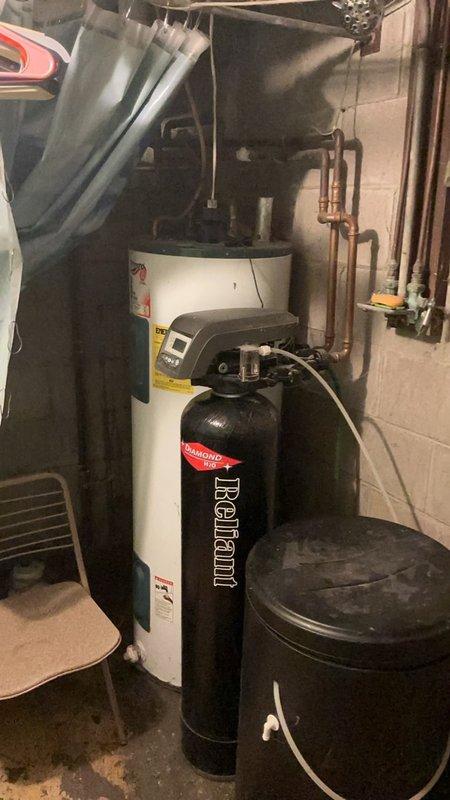 Responded to service call for malfunctioning water softener system experiencing overworking cycles and flooding issues. Upon inspection, determined unit required replacement due to operational failure. Capped off sink water supply lines to address dripping faucet concerns and prevent further water waste.