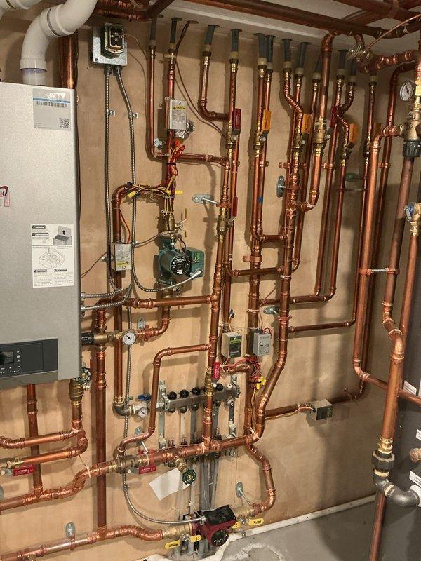 Completed comprehensive tune-up on 3-year-old NTI high-efficiency boiler system. Verified CO levels safe in flue, confirmed proper gas pressure, and inspected combustion blower and Venturi assembly. Checked water pressure and temperature readings for proper operation, confirmed expansion tank functioning correctly, and verified all zone motors opening and closing as designed. Cleared condensate trap and drain line, cleaned ignitor and flame rod to ensure reliable ignition. All system components tested and confirmed fully operational with no deficiencies noted.