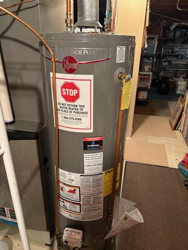 Responded to a leak at the top of a 2-year-old Rheem water heater. Upon inspection, identified a failed solder joint at the 90-degree elbow above the unit, which was causing active water leakage and significant corrosion at the connection point. Replaced the defective 90-degree fitting and the water heater shut-off valve to ensure proper seal and prevent future leaks.