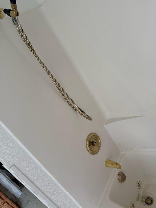 Completed replacement of tub and shower faucet system with Delta brand fixtures, including installation of new shower cartridge, tub spout, and trim components. Replaced broken shower cartridge and installed Geberit drain trim to restore full functionality. All fixtures installed and tested for proper operation in whirlpool tub configuration.