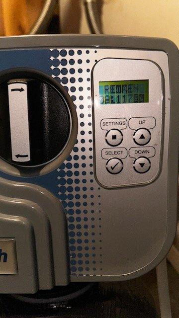 Responded to service alert on Hydrotech water softener system for new homeowner. Inspected water softener unit and reverse osmosis system for operational status and potential service issues. Found "FROZEN FILTER" alert displayed on control panel but determined no immediate mechanical failures present. Documented system condition with photos showing properly mounted equipment and functional control display. Coordinated with service advisor for follow-up water quality testing and comprehensive equipment verification to ensure optimal system performance.