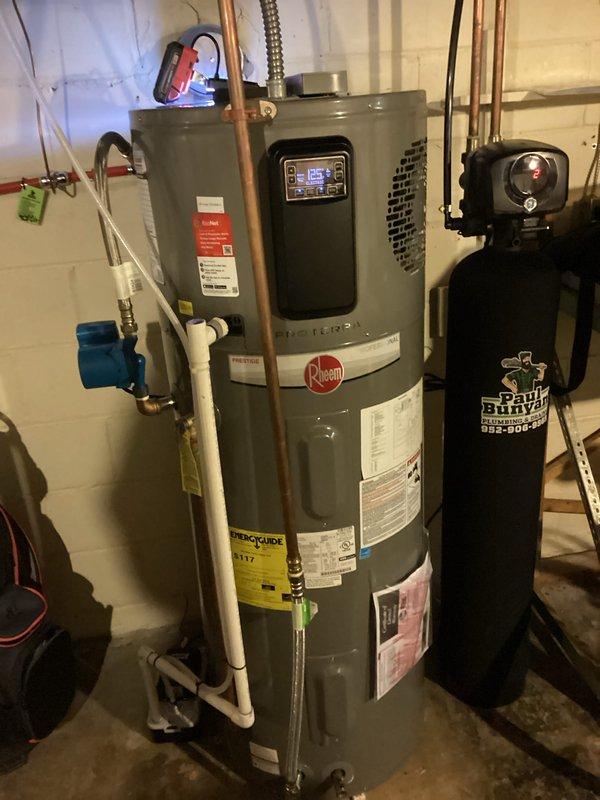 Responded to service call for approximately one-year-old Rheem hybrid heat pump water heater displaying compressor low airflow warning messages. Upon inspection, diagnosed evaporator coil icing condition despite recent filter replacement. Documented error codes and unit condition with photographs. Contacted manufacturer technical support to verify diagnosis and arrange warranty replacement part for evaporator coil assembly. Unit is covered under manufacturer warranty for parts replacement.