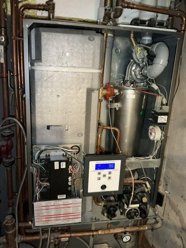 Performed comprehensive inspection on 10-year-old NTI high-efficiency boiler for home sale purposes. Verified water pressure and temperature within specifications, confirmed expansion tank operational, tested combustion blower and Venturi assembly functioning properly, measured gas pressure at correct levels, and conducted flue gas analysis confirming safe CO levels. All system components tested within manufacturer specifications; unit determined safe and fully operational.