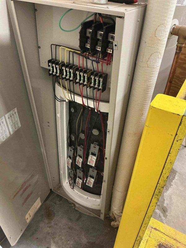 Responded to commercial water heater emergency at PetSmart location where unit had ruptured with active leak from bottom of tank. Upon arrival, immediately isolated water supply, shut down electrical power at panel, and secured the failed A.O. Smith Preferred model water heater to prevent further water damage to facility. Documented existing electrical connections and equipment condition with before photos for replacement planning and insurance purposes.