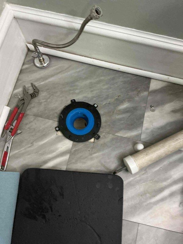 Responded to active water leak originating from toilet in living room area. Upon inspection, discovered existing toilet flange was improperly installed and failed, causing water intrusion into living space. Removed toilet and assessed damaged flange assembly. Removed defective flange hardware and prepared subfloor for proper installation. Installed new code-compliant toilet flange with appropriate mounting hardware and wax ring seal. Secured flange to floor structure per manufacturer specifications and plumbing code requirements. Reinstalled toilet and reconnected water supply line. Tested system for proper operation and verified leak resolution.