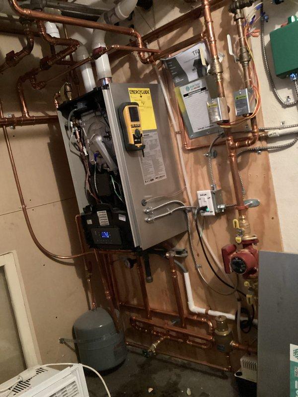 Completed comprehensive boiler tune-up on a 4-year-old residential heating system with no issues found. Performed standard maintenance procedures including inspection of blower motor assembly, burner components, electrical connections, and associated piping network with circulator pump and expansion tank, confirming all components operating within normal parameters.