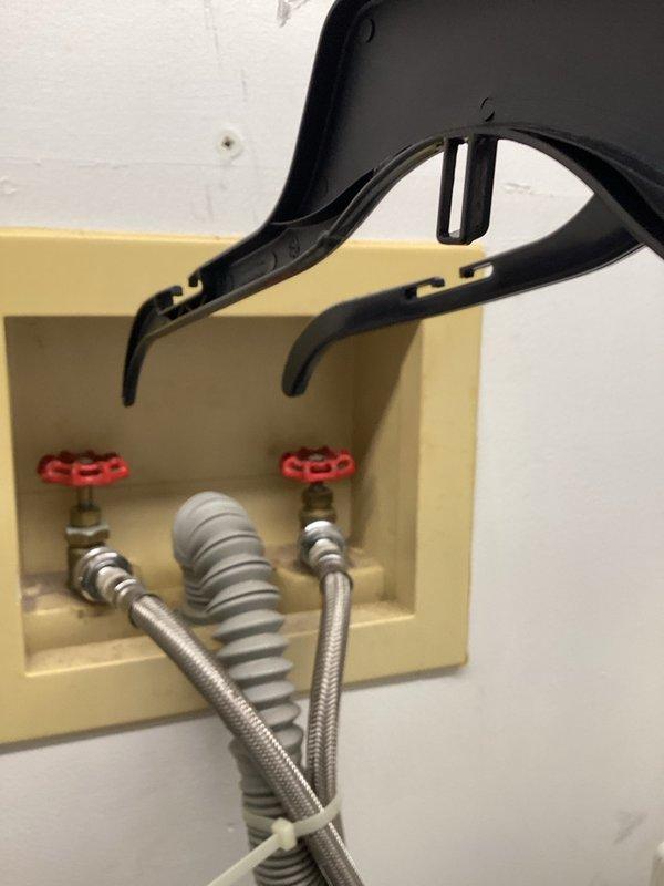 Completed comprehensive plumbing inspection on 1921-built residence as part of recurring maintenance service. Inspected shower valve assembly with brushed nickel trim and shut-off valve installation with flexible braided supply lines in recessed wall box. Documented current conditions and recommended water heater replacement due to age of existing unit.