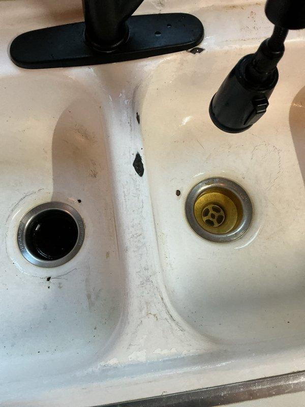 Responded to a kitchen sink backup and performed diagnostic evaluation. Found the drain exhibited slow drainage, indicating a blockage located beyond the trap assembly in the main drain line. Cabled the drain line and cleared the obstruction at approximately 40 feet from the access point. Continued cabling to the full 50-foot capacity of the drain machine while running water to ensure complete clearance and verify proper flow throughout the entire line. Reassembled all drain components and conducted final testing by filling and draining both sink basins. Confirmed drain system was fully operational with proper flow rate and no leaks detected at any connection points.