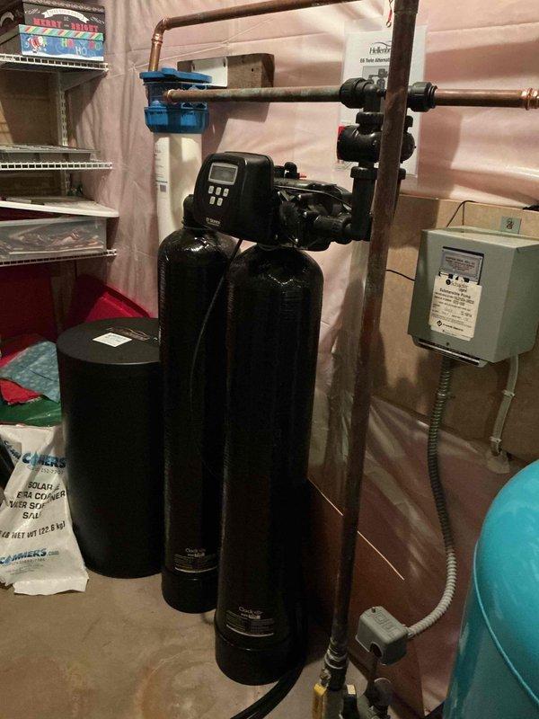 Responded to service call for whole house humidifier and air exchanger inspection on 20-year-old residential system. Upon arrival, tested air exchanger unit which was found to be operating within normal parameters. Inspected Aprilaire humidifier system and confirmed unit was non-operational. Performed diagnostic assessment and determined valve replacement required for proper humidifier function. Documented existing equipment conditions with photos showing water treatment system installation and humidifier control panel. Provided estimate for necessary repairs and replacement options to restore humidifier to working condition.