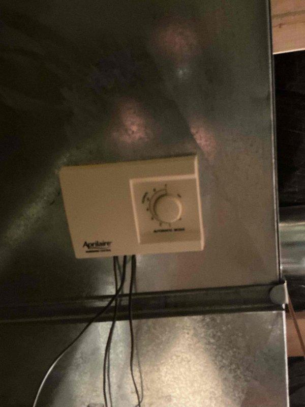 Responded to service call for whole house humidifier and air exchanger inspection on 20-year-old residential system. Upon arrival, tested air exchanger unit which was found to be operating within normal parameters. Inspected Aprilaire humidifier system and confirmed unit was non-operational. Performed diagnostic assessment and determined valve replacement required for proper humidifier function. Documented existing equipment conditions with photos showing water treatment system installation and humidifier control panel. Provided estimate for necessary repairs and replacement options to restore humidifier to working condition.