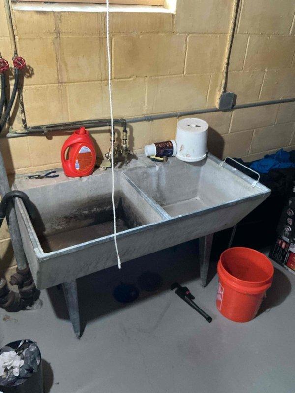 Responded to a floor drain backup occurring when the laundry tub was in use. Diagnosed the blockage as likely caused by lint accumulation in the drain line. Cabled the floor drain using a flex shaft machine to the full extent of the cable length while running water to clear the obstruction. Successfully restored proper drainage flow through the system. During inspection upon completion, identified that the laundry tub itself had a leak, which the property owner acknowledged and agreed to address separately. Verified all drains were open and flowing properly before concluding the service.
