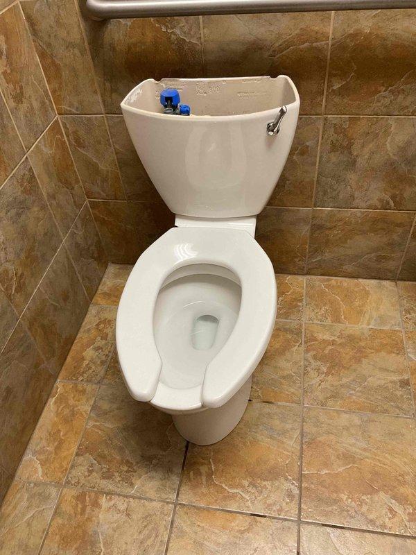 Responded to unisex bathroom facility for toilet replacement due to structural damage where the fixture was broken off from the rear wall mounting. Upon arrival, water supply was already shut off to the unit. Removed damaged toilet, inspected wall mounting area and flange connection, and installed new quiet-flush toilet system with proper wall anchoring and sealed connections. Tested unit for proper operation and verified no leaks at supply line or base seal.