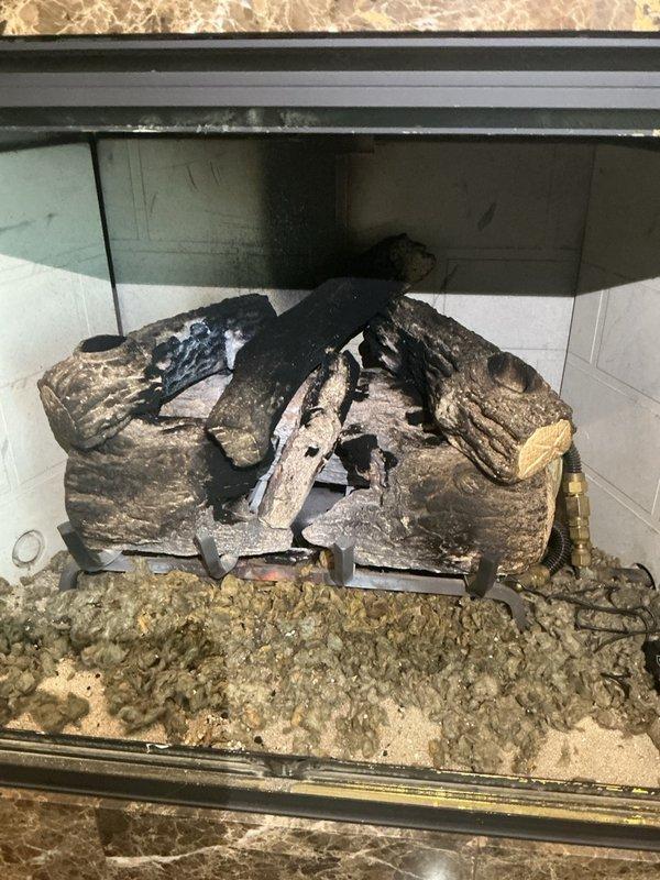 Responded to service call for two gas fireplace units with operational issues. Upon arrival, found upstairs fireplace with extinguished pilot light. Successfully relit pilot assembly and verified unit ignited immediately with proper flame pattern and continued operation. 

Addressed downstairs fireplace experiencing reported intermittent shutdown after approximately two minutes of runtime. Performed diagnostic inspection of flame sensor, which showed no visible defects or fouling. Replaced remote control batteries as preventive maintenance measure. Conducted extended operational test running unit continuously for twenty minutes with no shutdown occurrences, confirming system stability. Observed heavy soot accumulation and charring on ceramic log set indicating need for future maintenance cleaning. Both fireplace units left in proper working order with stable ignition and sustained operation verified.