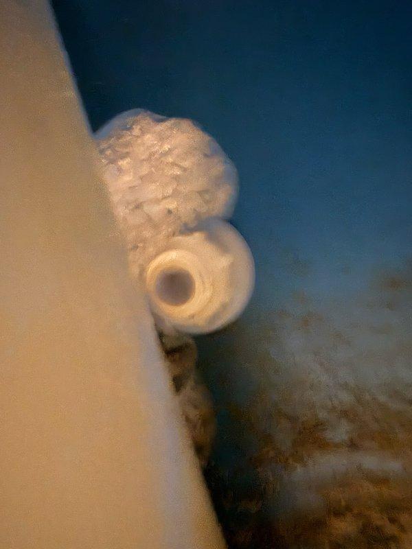 Responded to water softener malfunction causing excessive brine draw and unusual sucking noises. Upon inspection, discovered significant mineral buildup and deposits on the brine valve assembly and venturi system, which was preventing proper regeneration cycle completion. Diagnosed that the unit was overdrawing brine from the tank, resulting in premature salt depletion and contributing to rust staining issues in the household plumbing fixtures. Documented condition of internal components showing heavy scaling and recommended system maintenance to restore proper water softening function.