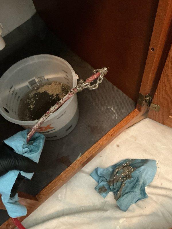 Responded to a clogged kitchen sink drain that was backing up due to heavy accumulation of grease and food debris, including egg shells. Successfully cleared the blockage using a small rigid drain snake machine, restoring proper drainage to the double-basin stainless steel sink. Cleaned work area and removed debris upon completion.