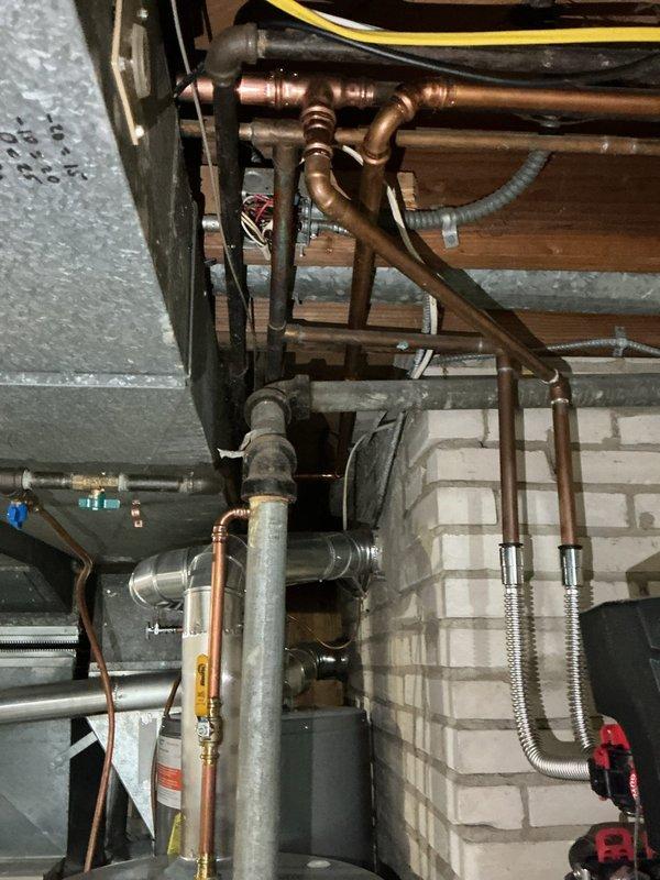 Responded to a water leak emergency involving a pinhole leak in a 1-inch diameter copper main line located just past the shut off valve. The copper piping, dating from the 1950s, had developed a small perforation requiring immediate repair to prevent water damage. Successfully repaired the compromised section of the main line, restoring full water pressure and eliminating the leak.