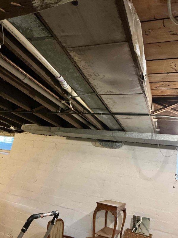Responded to callback for water leaking through ceiling from furnace area. Upon inspection, identified the flue connection pipe in basement as source of dripping. The existing flue section is aged and was not replaced during previous furnace installation. Attempted repair but insufficient clearance prevented proper fix. Due to confined workspace constraints, full replacement of flue section by installation crew is required to properly resolve the leak issue.