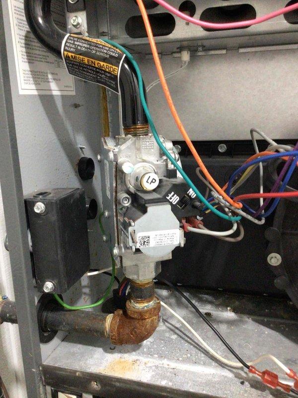 Completed furnace tune-up and diagnostic inspection on residential heating system. All electrical components tested and found within manufacturer specifications. During inspection, discovered gas valve stuck in closed position, preventing proper operation. Performed all standard maintenance procedures possible given equipment condition, including inspection of burner assembly, heat exchanger, blower components, and safety controls. Documented corroded copper gas line elbow at valve connection. Created parts order form for replacement gas valve to restore system to full operational status.