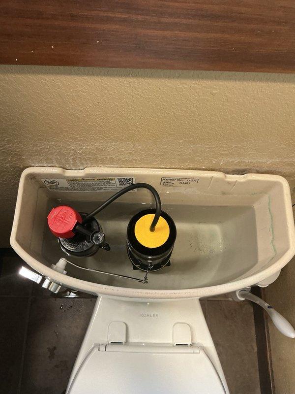 Responded to service call for malfunctioning toilet. Upon inspection, determined that both the intake valve and flush valve required replacement due to wear and operational failure. Successfully replaced the toilet fill valve (intake valve) with new assembly featuring red adjustment cap for proper water level control. Installed new flush valve assembly with yellow float mechanism to ensure reliable flushing performance. Tested both components for proper operation, verified water flow, checked for leaks, and confirmed flush cycle functionality. All internal tank mechanisms are now operating within manufacturer specifications.